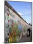 Couple Walking Along the East Side Gallery Berlin Wall Mural, Berlin, Germany, Europe-Simon Montgomery-Mounted Photographic Print