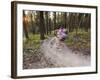 Courtney Feldt Mountain Bikes on Singletrack of the Whitefish Trail Near Whitefish, Montana, Usa-Chuck Haney-Framed Photographic Print