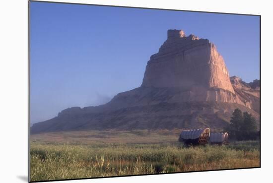 Covered Wagons on the Oregon Trail at Scotts Bluff, Nebraska, at Sunrise-null-Mounted Photographic Print