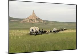 Covered Wagons Passing Chimney Rock, a Landmark on the Oregon Trail, Nebraska-null-Mounted Photographic Print