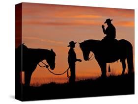 Cowboy and Cowgirl Silhouetted on a Ridge in the Big Horn Mountains, Wyoming, USA-Joe Restuccia III-Stretched Canvas