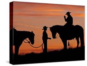 Cowboy and Cowgirl Silhouetted on a Ridge in the Big Horn Mountains, Wyoming, USA-Joe Restuccia III-Stretched Canvas