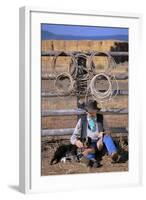 Cowboy and Dog Sitting Against Fence-Darrell Gulin-Framed Photographic Print