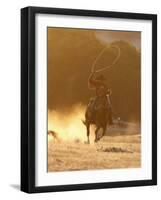 Cowboy Galloping While Swinging a Rope Lassoo at Sunset, Flitner Ranch, Shell, Wyoming, USA-Carol Walker-Framed Photographic Print