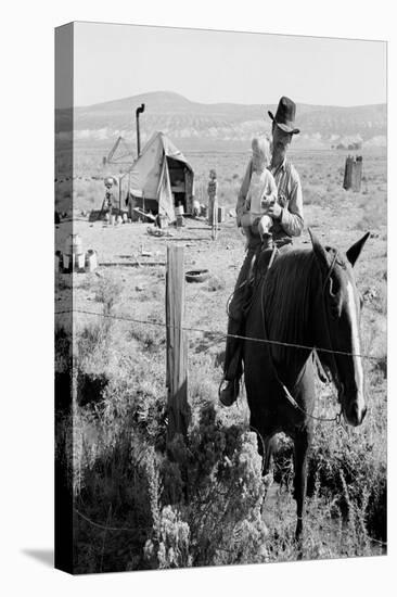 Cowboy Holds His Baby While Riding a Horse-Dorothea Lange-Stretched Canvas