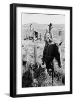 Cowboy Holds His Baby While Riding a Horse-Dorothea Lange-Framed Art Print