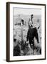 Cowboy Holds His Baby While Riding a Horse-Dorothea Lange-Framed Art Print