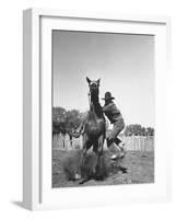 Cowboy Mounting a Horse-Carl Mydans-Framed Photographic Print