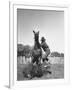 Cowboy Mounting a Horse-Carl Mydans-Framed Photographic Print