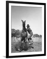 Cowboy Mounting a Horse-Carl Mydans-Framed Photographic Print