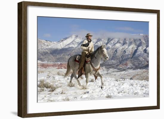 Cowboy On Grey Quarter Horse Trotting In The Snow At Flitner Ranch, Shell, Wyoming-Carol Walker-Framed Photographic Print