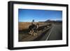 Cowboy on his horse on a highway near Hanksville, Utah, USA-null-Framed Art Print