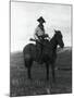 Cowboy on Horseback with Rifle-null-Mounted Photographic Print
