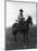 Cowboy on Horseback with Rifle-null-Mounted Photographic Print