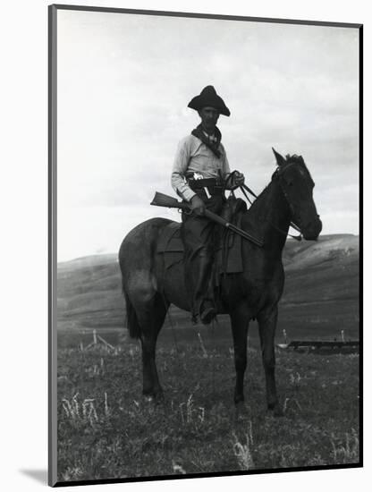 Cowboy on Horseback with Rifle-null-Mounted Photographic Print