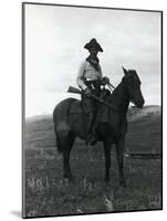 Cowboy on Horseback with Rifle-null-Mounted Photographic Print