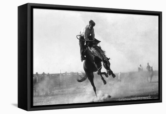 Cowboy riding Bronco in Burns, OR Rodeo Photograph - Burns, OR-Lantern Press-Framed Stretched Canvas