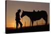 Cowboy Standing with His Horse-Darrell Gulin-Stretched Canvas