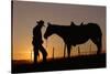 Cowboy Standing with His Horse-Darrell Gulin-Stretched Canvas