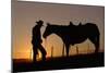 Cowboy Standing with His Horse-Darrell Gulin-Mounted Photographic Print