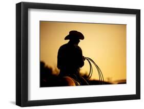 Cowboy with Lasso Silhouette at Small-Town Rodeo. Buyers Note: Image Contains Added Grain to Enhanc-Sascha Burkard-Framed Photographic Print