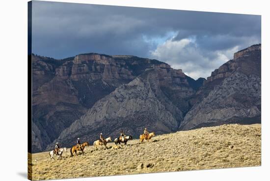 Cowboys and Cowgirls Riding along the Hills of the Big Horn Mountains-Terry Eggers-Stretched Canvas