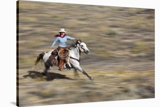 Cowgirl Riding at Full Speed in Motion-Terry Eggers-Stretched Canvas