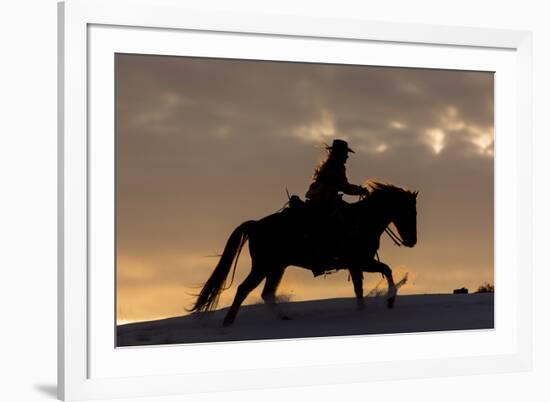 Cowgirl riding her horse in winter, Hideout Ranch, Shell, Wyoming.-Darrell Gulin-Framed Photographic Print