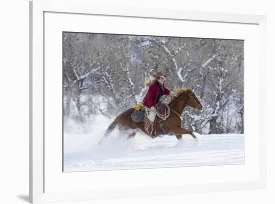 Cowgirl riding her horse in winter, Hideout Ranch, Shell, Wyoming.-Darrell Gulin-Framed Photographic Print