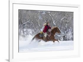 Cowgirl riding her horse in winter, Hideout Ranch, Shell, Wyoming.-Darrell Gulin-Framed Photographic Print