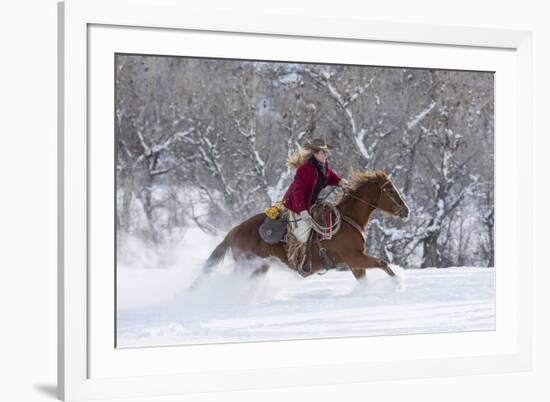 Cowgirl riding her horse in winter, Hideout Ranch, Shell, Wyoming.-Darrell Gulin-Framed Photographic Print