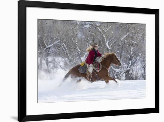 Cowgirl riding her horse in winter, Hideout Ranch, Shell, Wyoming.-Darrell Gulin-Framed Photographic Print