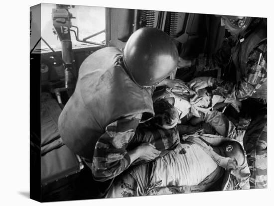 Cpl. James Farley and Pfc. Wayne Hoilien Bandaging Sgt. Billie Owens' Shoulder, Yankee Papa 13-Larry Burrows-Stretched Canvas