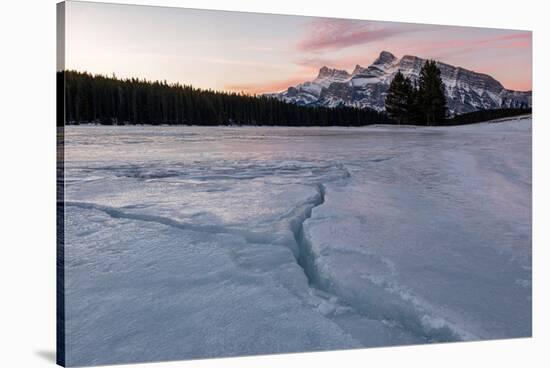 Cracks in ice on frozen lake at sunrise, Mount Rundle, Banff National Park, Alberta, Canada-null-Stretched Canvas