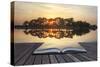 Creative Concept Image of Refelcted Lake Sunset Coming out of Pages in Magical Book-Veneratio-Stretched Canvas