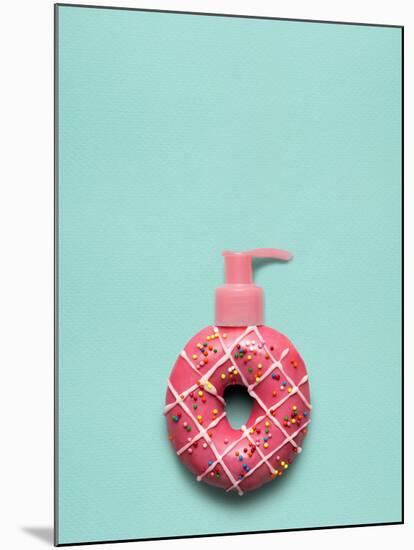 Creative Still Life of a Tasty Sweet Donut with a Cosmetic Pump Dispenser on Blue Background-Fisher Photostudio-Mounted Photographic Print