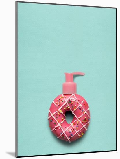 Creative Still Life of a Tasty Sweet Donut with a Cosmetic Pump Dispenser on Blue Background-Fisher Photostudio-Mounted Photographic Print
