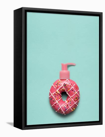 Creative Still Life of a Tasty Sweet Donut with a Cosmetic Pump Dispenser on Blue Background-Fisher Photostudio-Framed Stretched Canvas