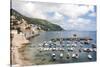 Croatia, Dubrovnik. View of marina and coastline from old city wall. Fisherman stands on shore.-Trish Drury-Stretched Canvas