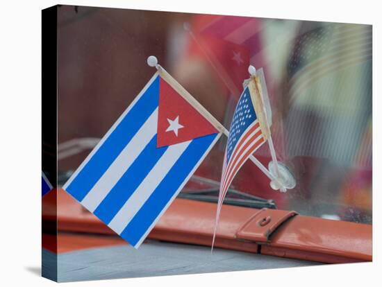 Cuba, Havana, Havana Vieja (Old Havana), Cuban and US flags on dashboard of car.-Merrill Images-Stretched Canvas