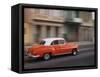 Cuba, Havana, Havana Vieja, UNESCO World Heritage Site, classic red car in motion-Merrill Images-Framed Stretched Canvas