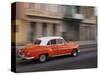 Cuba, Havana, Havana Vieja, UNESCO World Heritage Site, classic red car in motion-Merrill Images-Stretched Canvas