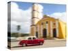 Cuba, Remedios, classic red car in front of Cathedral.-Merrill Images-Stretched Canvas