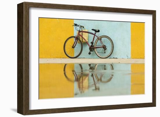 Cuba, Trinidad. Bicycle and reflection against yellow and blue walls.-Brenda Tharp-Framed Photographic Print