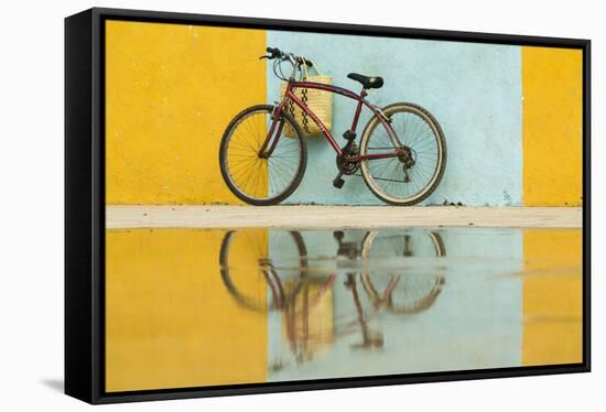 Cuba, Trinidad. Bicycle and reflection against yellow and blue walls.-Brenda Tharp-Framed Stretched Canvas