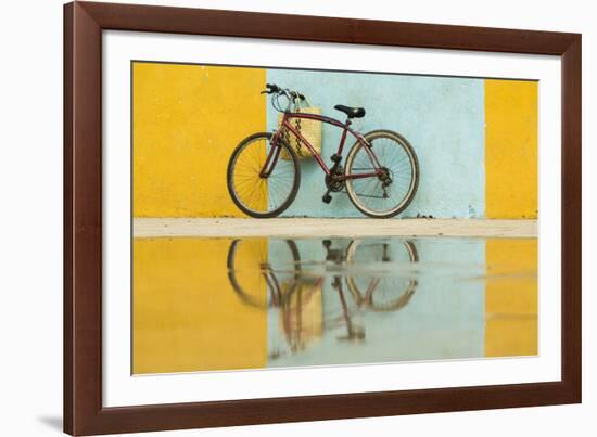 Cuba, Trinidad. Bicycle and reflection against yellow and blue walls.-Brenda Tharp-Framed Photographic Print