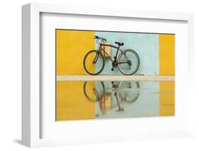 Cuba, Trinidad. Bicycle and reflection against yellow and blue walls.-Brenda Tharp-Framed Photographic Print