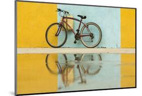 Cuba, Trinidad. Bicycle and reflection against yellow and blue walls.-Brenda Tharp-Mounted Photographic Print