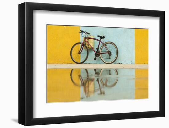 Cuba, Trinidad. Bicycle and reflection against yellow and blue walls.-Brenda Tharp-Framed Premium Photographic Print