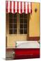 Cuba, Trinidad. Colorful Building and Striped Awning Compliment the Red Color of a Ford Fairlane-Brenda Tharp-Mounted Photographic Print